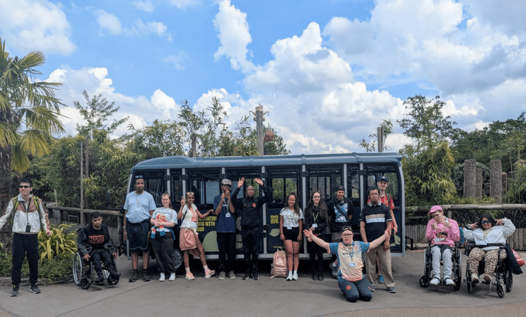 A group of learners posing in front of the college bus at Chester Zoo